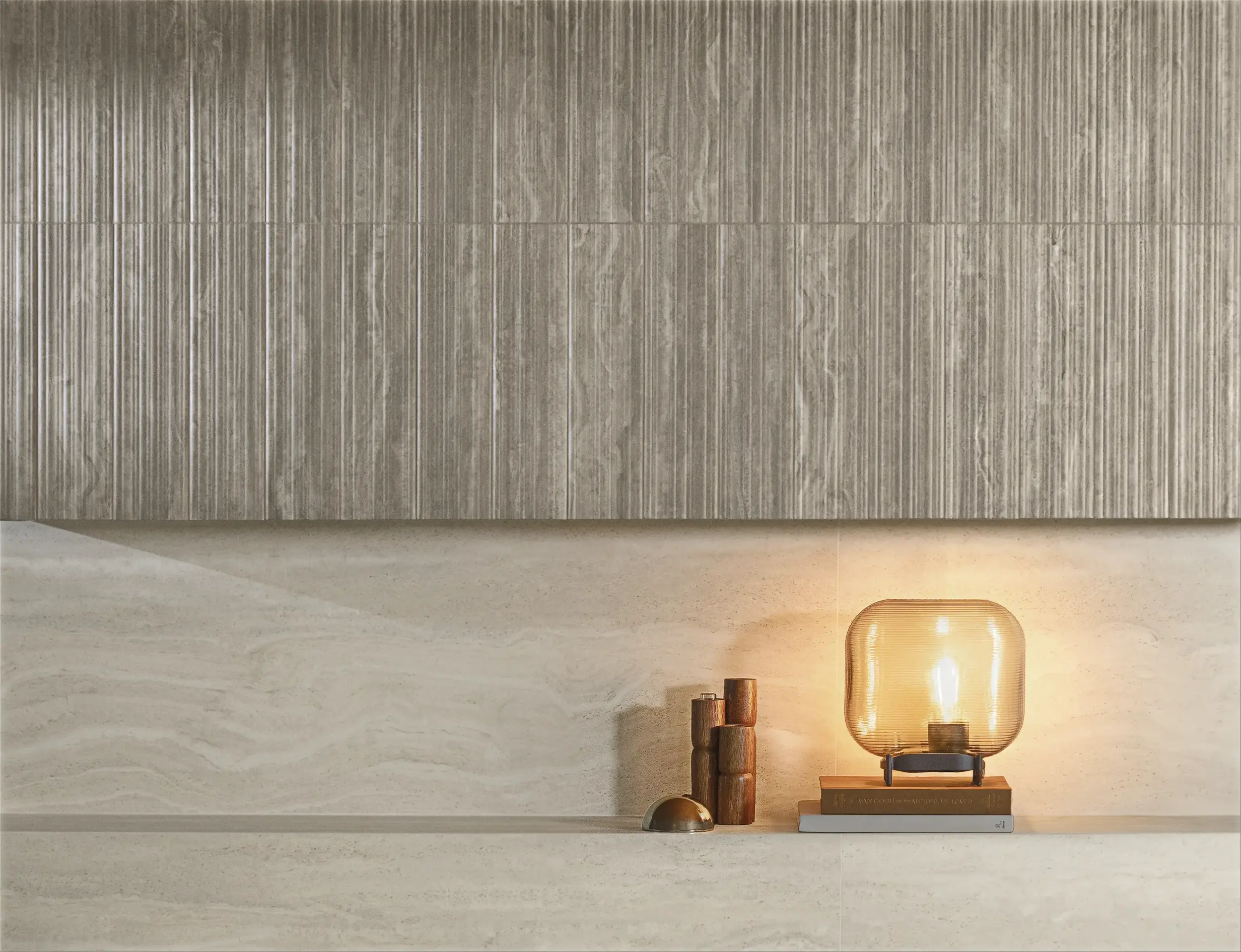 Beige ceramic wall tile with vertical texture, featuring soft indirect lighting and minimalist decor objects