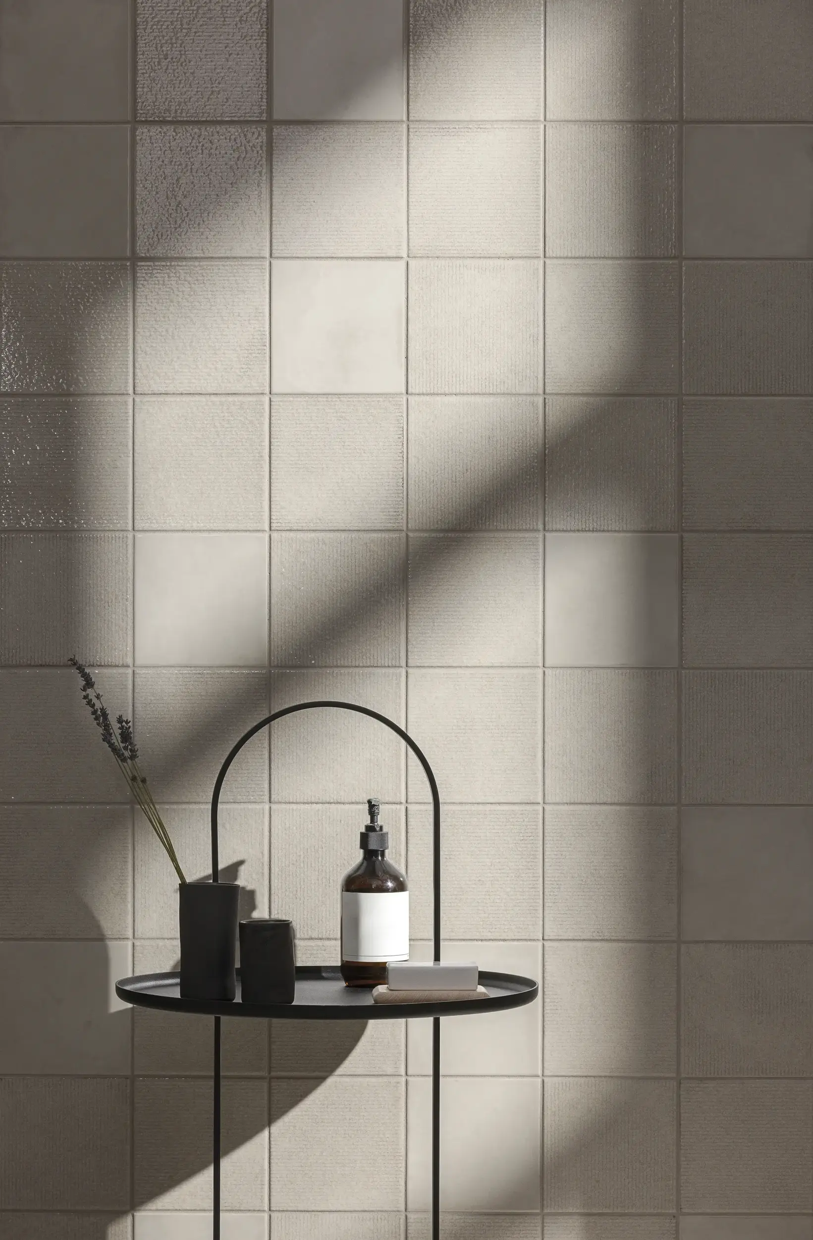 Light beige wall tiles with soft shadows and minimal decor