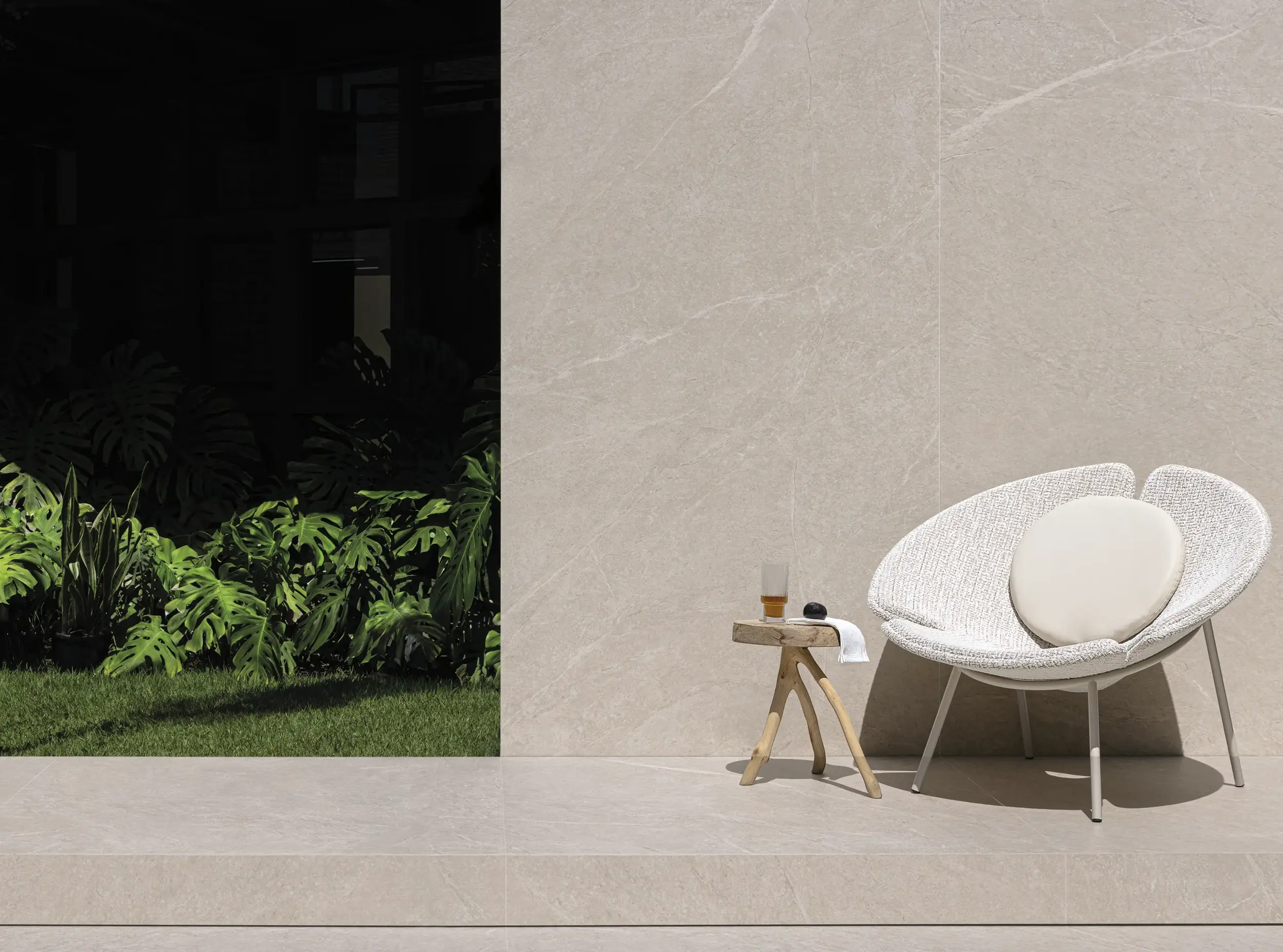 Exterior scene with beige wall tile, garden view and modern lounge chair